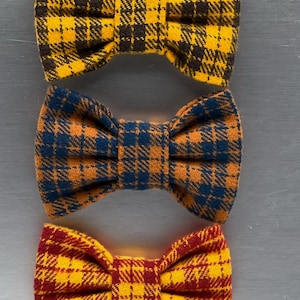 May include: A set of three ceramic mugs with a speckled, matte finish. The mugs are in cream, light grey, and dark grey. Each mug has a simple, minimalist design, ideal for coffee or tea.