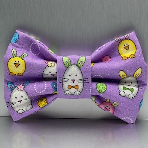 May include: Purple bow tie with a repeating pattern of Easter bunnies, chicks, and eggs.