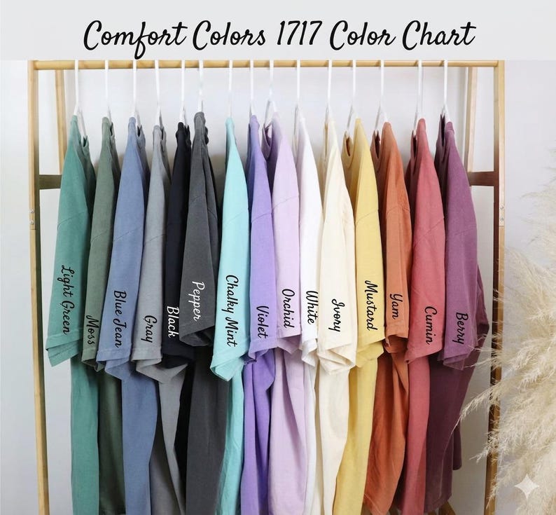 A rack displaying a variety of colorful t-shirts, each with a different color and a corresponding name written on it.