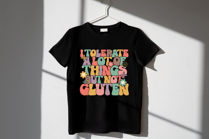May include: Black t-shirt with a colorful retro-style graphic that says "I tolerate a lot of things but not gluten".