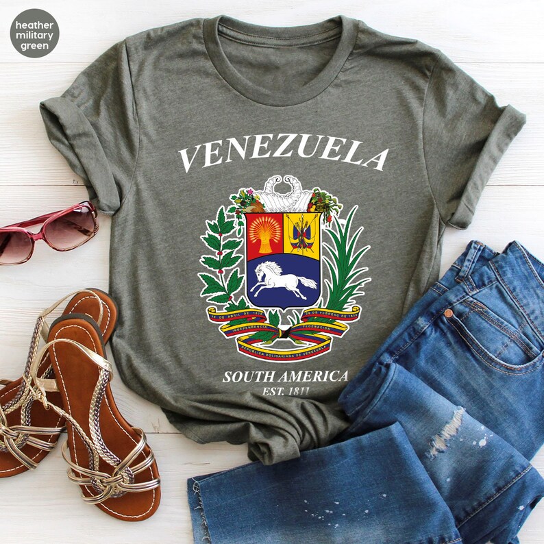 a t - shirt that says venezuela with a coat of arms on it