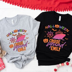 a couple of t - shirts sitting on top of a table