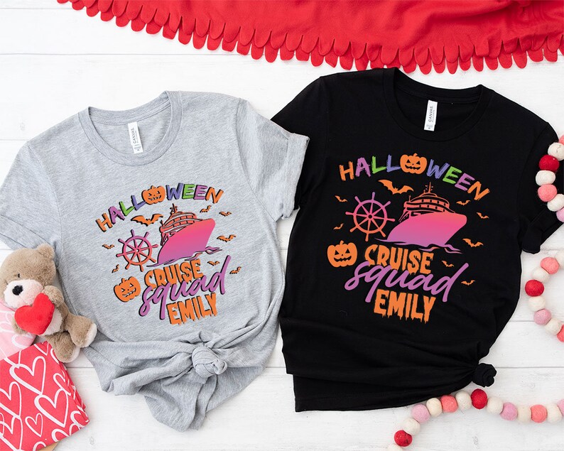 a couple of t - shirts sitting on top of a table