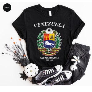 a t - shirt that says venezuela with a coat of arms on it