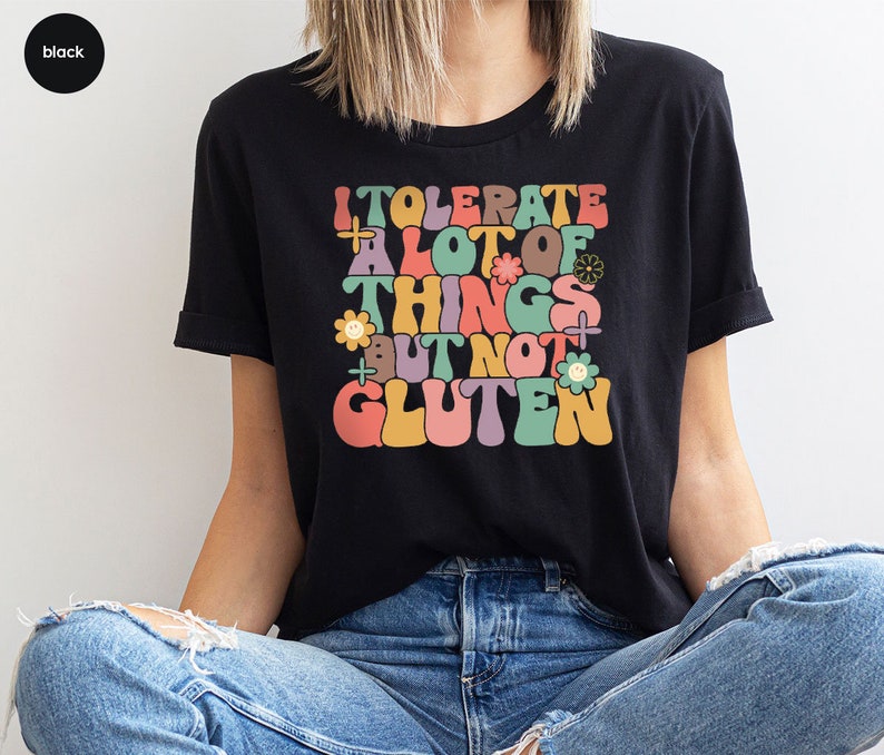 May include: A black t-shirt with a colorful graphic that says "I tolerate a lot of things but not gluten".
