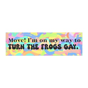 May include: A rectangular sign with a colorful, abstract background of brushstrokes in pastel shades. Bold black text reads "Move! I'm on my way to TURN THE FROGS GAY."