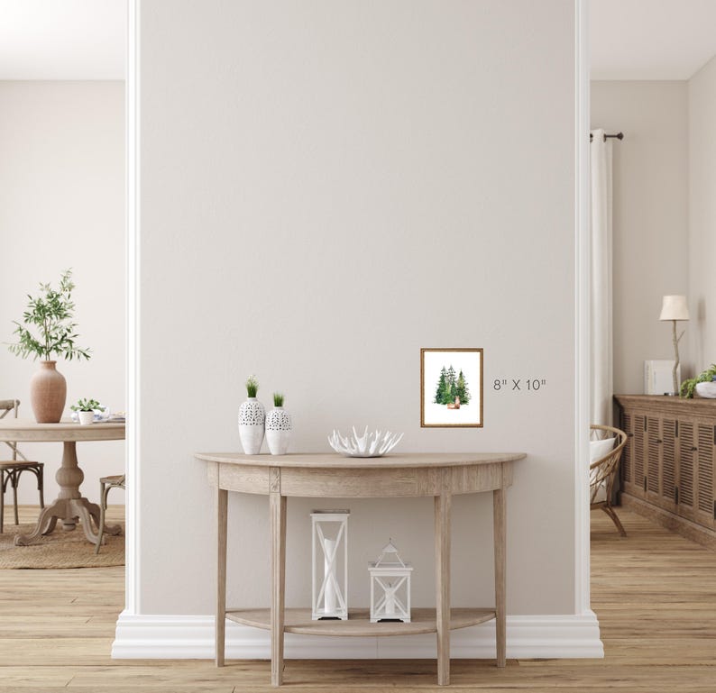 Puede incluir: Una pintura de acuarela enmarcada que representa una escena de bosque con &aacute;rboles verdes. El marco es de madera marr&oacute;n y la pintura mide 20,32 cm por 25,4 cm.