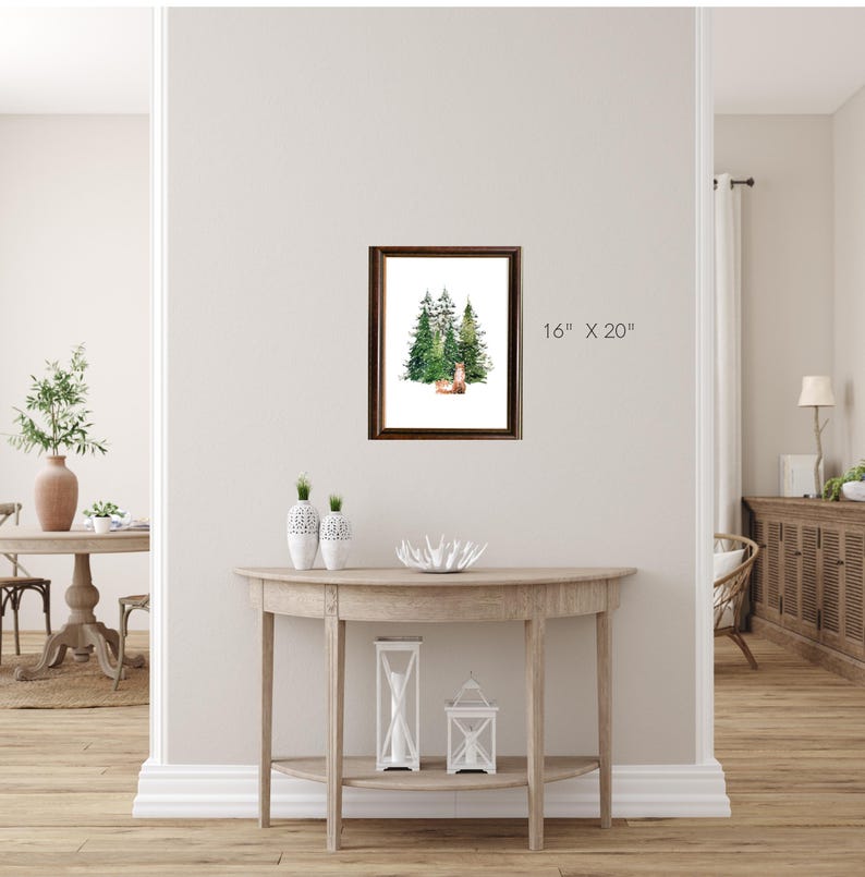 Puede incluir: Una pintura de acuarela enmarcada que representa una escena de bosque con tres &aacute;rboles verdes y un peque&ntilde;o ciervo en el centro. El marco es de madera marr&oacute;n y el passe-partout es blanco. La pintura mide 16 pulgadas por 20 pulgadas.