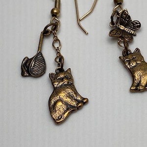 Fun cat earrings with tennis raquet and butterfly!