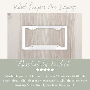 May include: A white metal license plate frame with four holes for mounting. The frame is on a light wood background. The text "Absolutely Perfect" is written in cursive below the frame. Five stars are below the text.