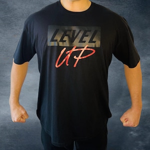 May include: Black t-shirt with a graphic print that says "LEVEL UP" in red and black.