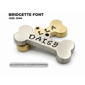 May include: Bone-shaped pet tag with the name "DAISY" in black lettering. The tag is silver with a gold-colored base. The text "BRIDGETTE FONT" and "SIZE: 3MM" are displayed above the tag. Bridgette font example on personalized dog tags engraved for pets showing custom dog name tag