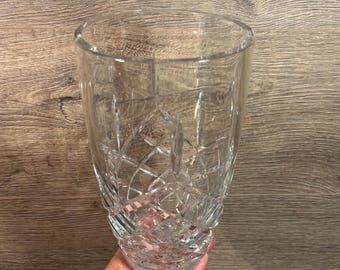 May include: A clear glass vase with a cut crystal design. The vase is tall and slender with a round base.