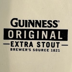 May include: Cream-colored background with the black text "Guinness Original Extra Stout Brewer's Source 1821". The Guinness logo is at the top, with "Original" in a black rectangle below it.