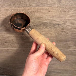 May include: A set of three ceramic mugs with a speckled, matte finish. The mugs are in shades of cream, light gray, and dark gray. Each mug has a simple, minimalist design and a rounded handle.