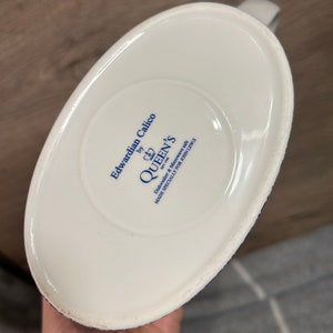 May include: White ceramic jug with a blue and white floral pattern. The base of the jug reads "Edwardian Calico by Queen's Dishwasher & Microwave Safe Made Specially For John Lewis".