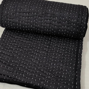 Minimalist black cotton quilt with traditional Kantha work.