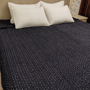 Soft handmade cotton blanket in elegant monochrome style.
