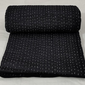 Cozy monochrome Kantha quilt with handmade detailing.