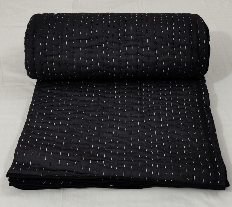 Cozy monochrome Kantha quilt with handmade detailing.