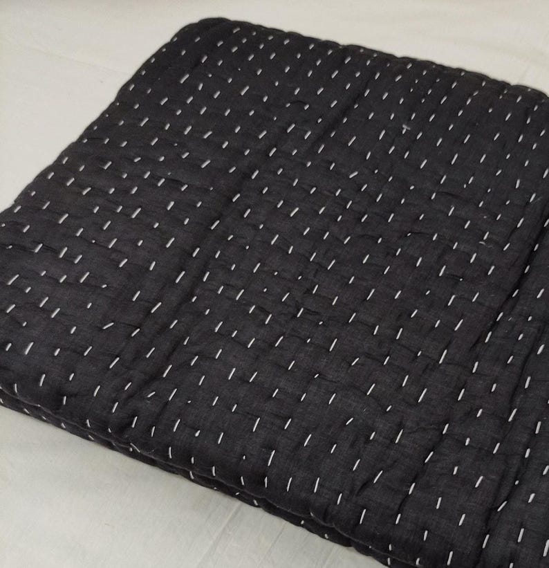 Black handstitched quilt with cozy textured cotton layers.