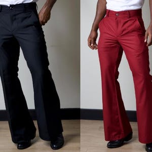 May include: Two pairs of flared trousers, one black and one red. Both trousers have a wide leg opening and a high waist.