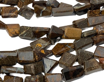 May include: A strand of brown and black opal gemstone beads. The beads are faceted and have a variety of shapes, including rectangular and triangular. The beads are strung on a wire and are ready to be used in jewelry making.