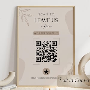 May include: A framed sign with a beige background displays the text "SCAN TO LEAVE US a Review" and "WE APPRECIATE IT!". A large QR code is centered below the text, with the words "YOUR FEEDBACK HELP US GROW" at the bottom. The words "Edit in Canva" are in the bottom right corner.