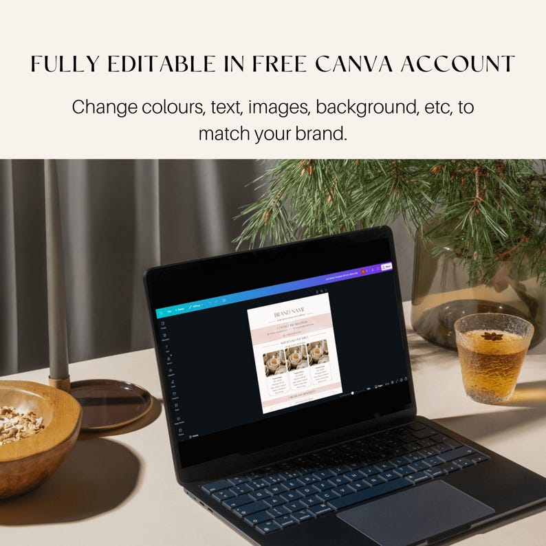 May include: A laptop displaying a design template with the text "BRAND NAME" and "FULLY EDITABLE IN FREE CANVA ACCOUNT". The laptop is on a light-colored surface, with a bowl, a candle, and a glass of liquid nearby.