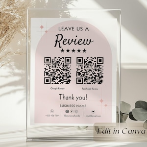 Puede incluir: Un letrero acrílico transparente con un diseño rosa y blanco. El letrero dice "LEAVE US A Review" con cinco estrellas, dos códigos QR y "Thank you!" También incluye información de contacto y el texto "Edit in Canva."