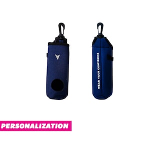 May include: Two blue golf ball holders with a black clip and a white logo. One holder has the text "WEAR YOUR CONFIDENCE" printed on it.