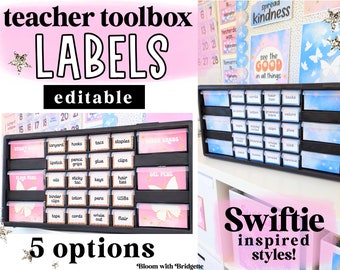 May include: A black plastic drawer organizer with labels for a teacher's toolbox. The labels are pink and blue with a butterfly design. The labels are editable and there are 5 options. The text on the labels includes "Sticky Notes", "Lanyard", "Hooks", "Tacks", "Staples", "Index Cards", "Lipstick", "Pencil Grips", "Glue", "Clips", "Flag Pens", "Oils", "Sticky Tac", "Keys", "Hair Ties", "Binder Clips", "Lotion", "Pens", "USBs", "Tape", "Cords", "White Out", "Flair", and "Gel Pens".