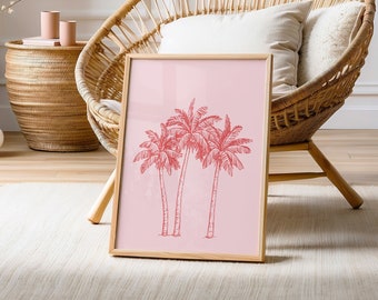 May include: A pink framed print with a drawing of three palm trees in a light pink color on a light pink background. The print is sitting on a wicker chair with a white cushion.