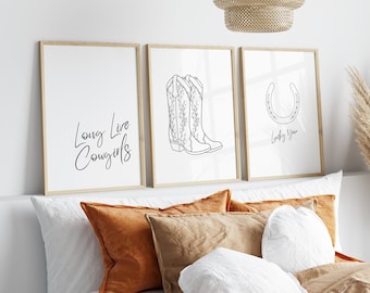 May include: Three framed prints with black and white line drawings. The first print says "Long Live Cowgirls". The second print shows a pair of cowboy boots. The third print shows a horseshoe with the text "Lucky You".