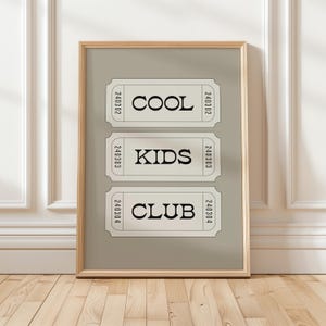 Typography wall art featuring three stacked ticket style designs with the words “Cool Kids Club” in bold black lettering on a neutral taupe background. Minimalist modern graphic print with a playful, retro inspired feel. This listing is for a digital download only. No physical print or frame included.