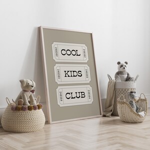 Typography wall art featuring three stacked ticket style designs with the words “Cool Kids Club” in bold black lettering on a neutral taupe background. Minimalist modern graphic print with a playful, retro inspired feel. This listing is for a digital download only. No physical print or frame included.