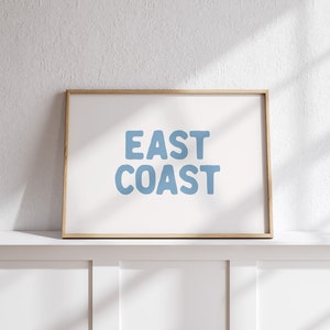 Minimalist typography wall art featuring the words “East Coast” in soft blue lettering on a clean off-white background. A modern, coastal-inspired print perfect for beach house decor, summer homes, living rooms, bedrooms or relaxed contemporary spaces. The simple design and airy colour palette create an effortless, laid-back seaside feel. This listing is for a digital download only. No physical print or frame included.