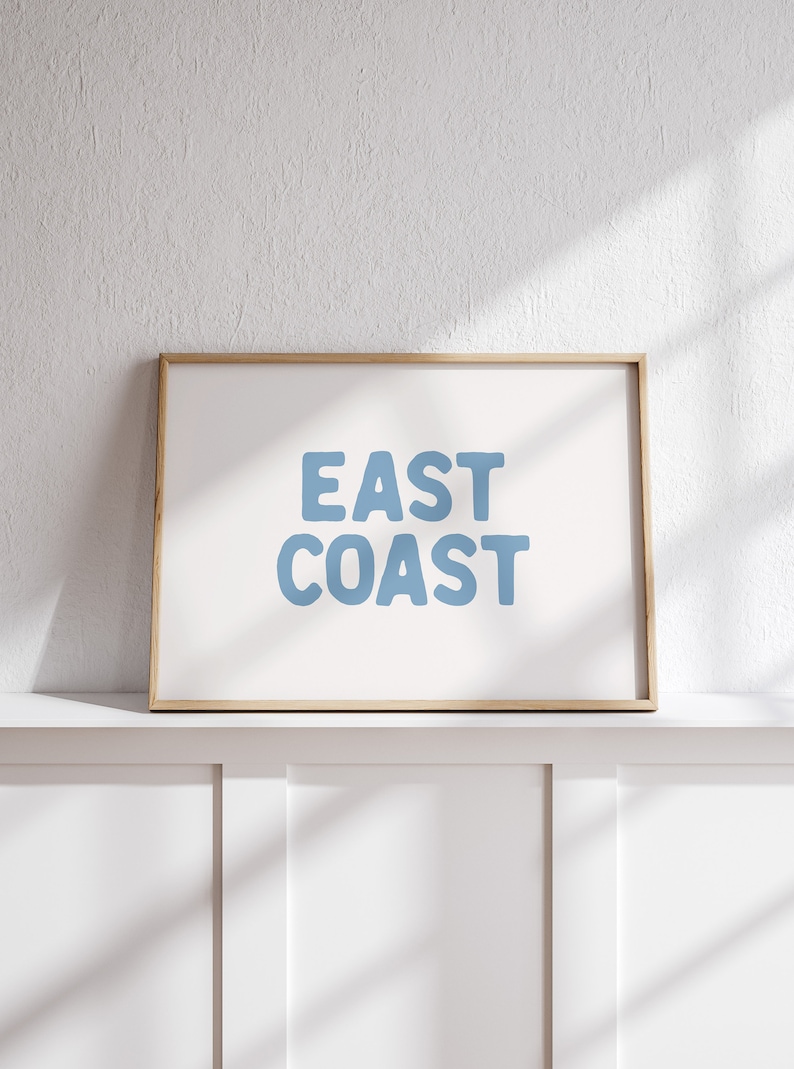 Minimalist typography wall art featuring the words “East Coast” in soft blue lettering on a clean off-white background. A modern, coastal-inspired print perfect for beach house decor, summer homes, living rooms, bedrooms or relaxed contemporary spaces. The simple design and airy colour palette create an effortless, laid-back seaside feel. This listing is for a digital download only. No physical print or frame included.