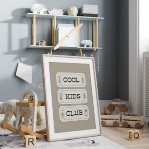 Typography wall art featuring three stacked ticket style designs with the words “Cool Kids Club” in bold black lettering on a neutral taupe background. Minimalist modern graphic print with a playful, retro inspired feel. This listing is for a digital download only. No physical print or frame included.