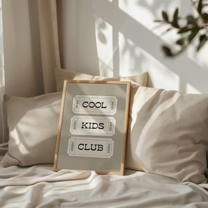 Typography wall art featuring three stacked ticket style designs with the words “Cool Kids Club” in bold black lettering on a neutral taupe background. Minimalist modern graphic print with a playful, retro inspired feel. This listing is for a digital download only. No physical print or frame included.