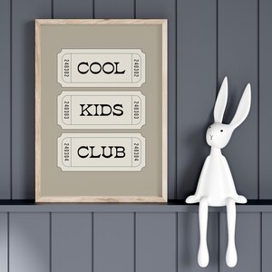 Typography wall art featuring three stacked ticket style designs with the words “Cool Kids Club” in bold black lettering on a neutral taupe background. Minimalist modern graphic print with a playful, retro inspired feel. This listing is for a digital download only. No physical print or frame included.