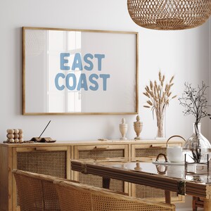 Minimalist typography wall art featuring the words “East Coast” in soft blue lettering on a clean off-white background. A modern, coastal-inspired print perfect for beach house decor, summer homes, living rooms, bedrooms or relaxed contemporary spaces. The simple design and airy colour palette create an effortless, laid-back seaside feel. This listing is for a digital download only. No physical print or frame included.