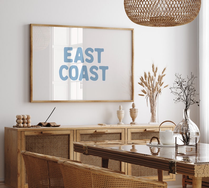 Minimalist typography wall art featuring the words “East Coast” in soft blue lettering on a clean off-white background. A modern, coastal-inspired print perfect for beach house decor, summer homes, living rooms, bedrooms or relaxed contemporary spaces. The simple design and airy colour palette create an effortless, laid-back seaside feel. This listing is for a digital download only. No physical print or frame included.