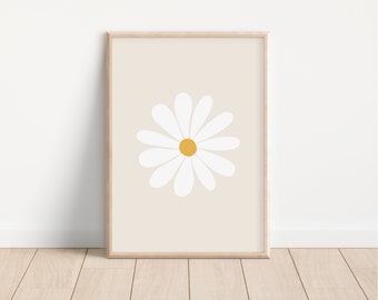 May include: A framed print of a white daisy with a yellow center on a beige background.