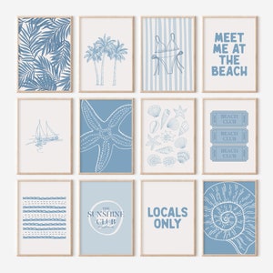 May include: A set of ten blue and white printable wall art prints with beach-themed illustrations and text. The prints feature images of palm trees, seashells, a sailboat, a starfish, a seashell, and a ticket that says "Beach Club". The text on the prints includes "Meet me at the beach", "The Sunshine Club", and "Locals Only".