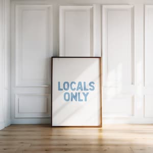 May include: A framed print with the text "LOCALS ONLY" in blue lettering on a white background.