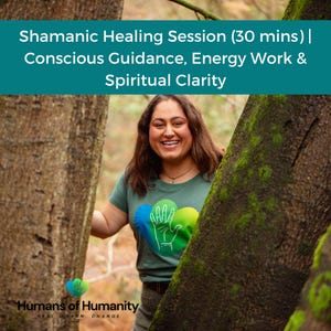 May include: A woman smiles, framed by trees, wearing a green t-shirt with a heart-shaped design. The shirt features a hand graphic and the words "Humans of Humanity." Text at the top reads "Shamanic Healing Session (30 mins) | Conscious Guidance, Energy Work & Spiritual Clarity."