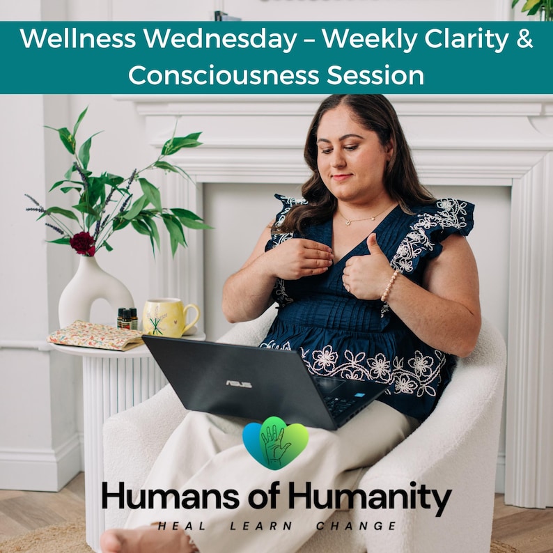May include: A woman in a navy blue top with white floral embroidery sits in a white chair, using a laptop. The image includes text that reads "Wellness Wednesday - Weekly Clarity & Consciousness Session" and "Humans of Humanity". A yellow mug and a vase with flowers are on a side table.