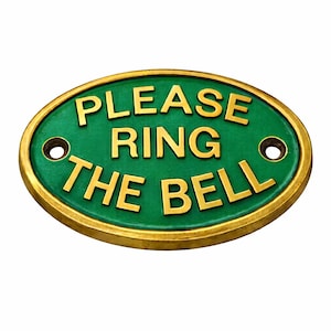 May include: An oval-shaped metal sign with a green background and a raised gold-coloured border. The sign features the embossed gold-coloured text "PLEASE RING THE BELL" and includes two circular mounting holes on the left and right sides. nautical door sign, nautical door plaque, nautical wall plaque, nautical wall decor, nautical home decor, nautical door decor, nautical entry sign, nautical entrance sign, nautical decor, maritime sign, maritime plaque, maritime brass sign