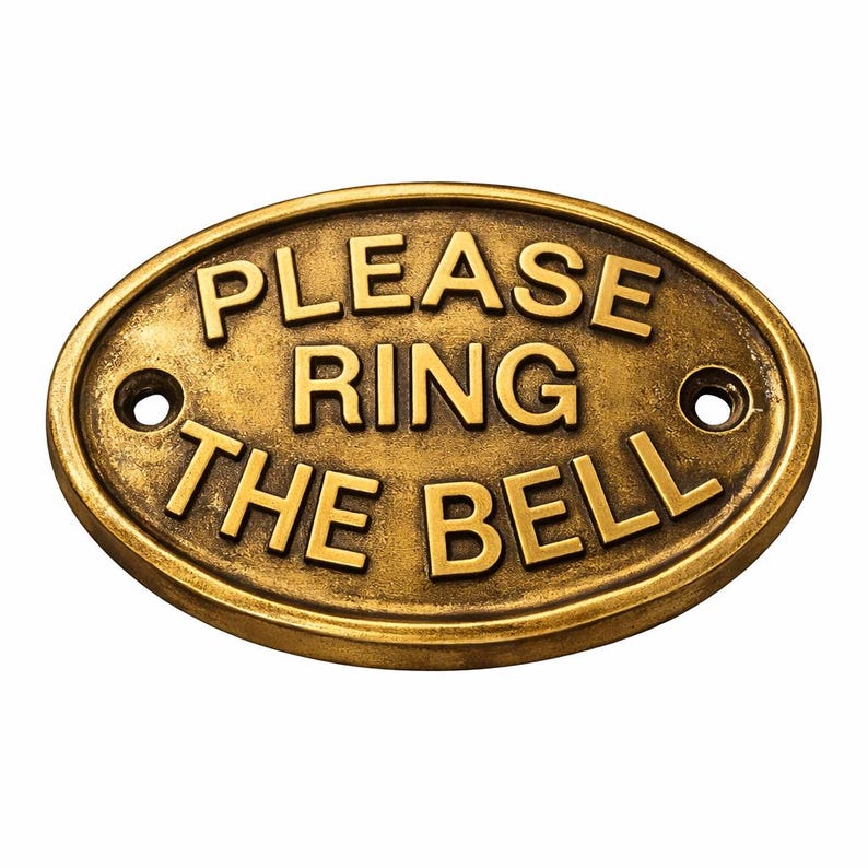 May include: An oval-shaped brass plaque with a weathered, antique finish. The sign features raised lettering that reads "PLEASE RING THE BELL" in three lines. There are two circular mounting holes, one on the left and one on the right side. brass home decor, brass entry plaque, brass entrance plaque, brass door plate, brass sign plaque, brass cast sign, handmade brass sign, handmade brass plaque, handcrafted plaque, handcrafted sign, artisan brass plaque, artisan brass sign